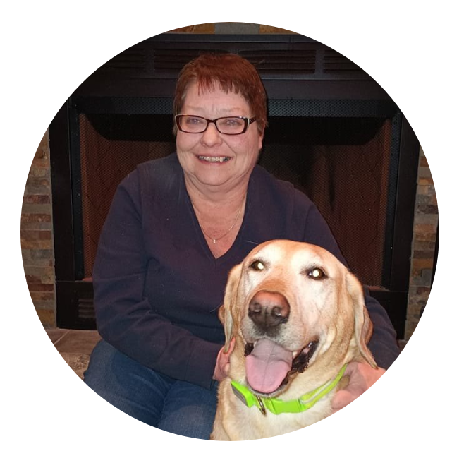 Joan, owner of Murry's Place, with Murry the yellow Labrador