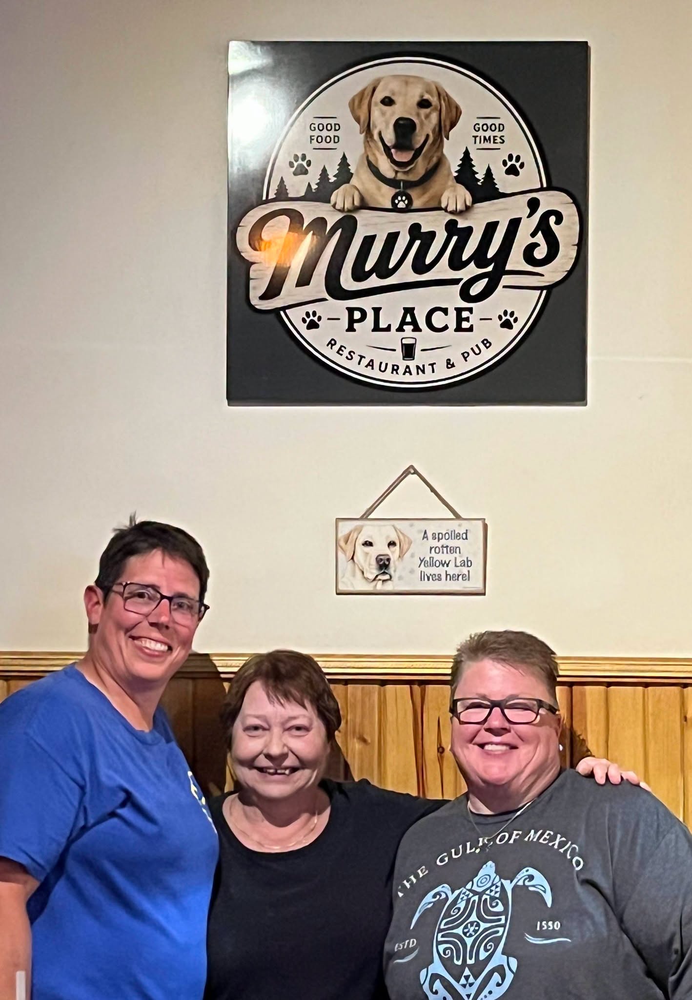 Crystal and Ingrid with the sign they made for Joan at Murry's Place