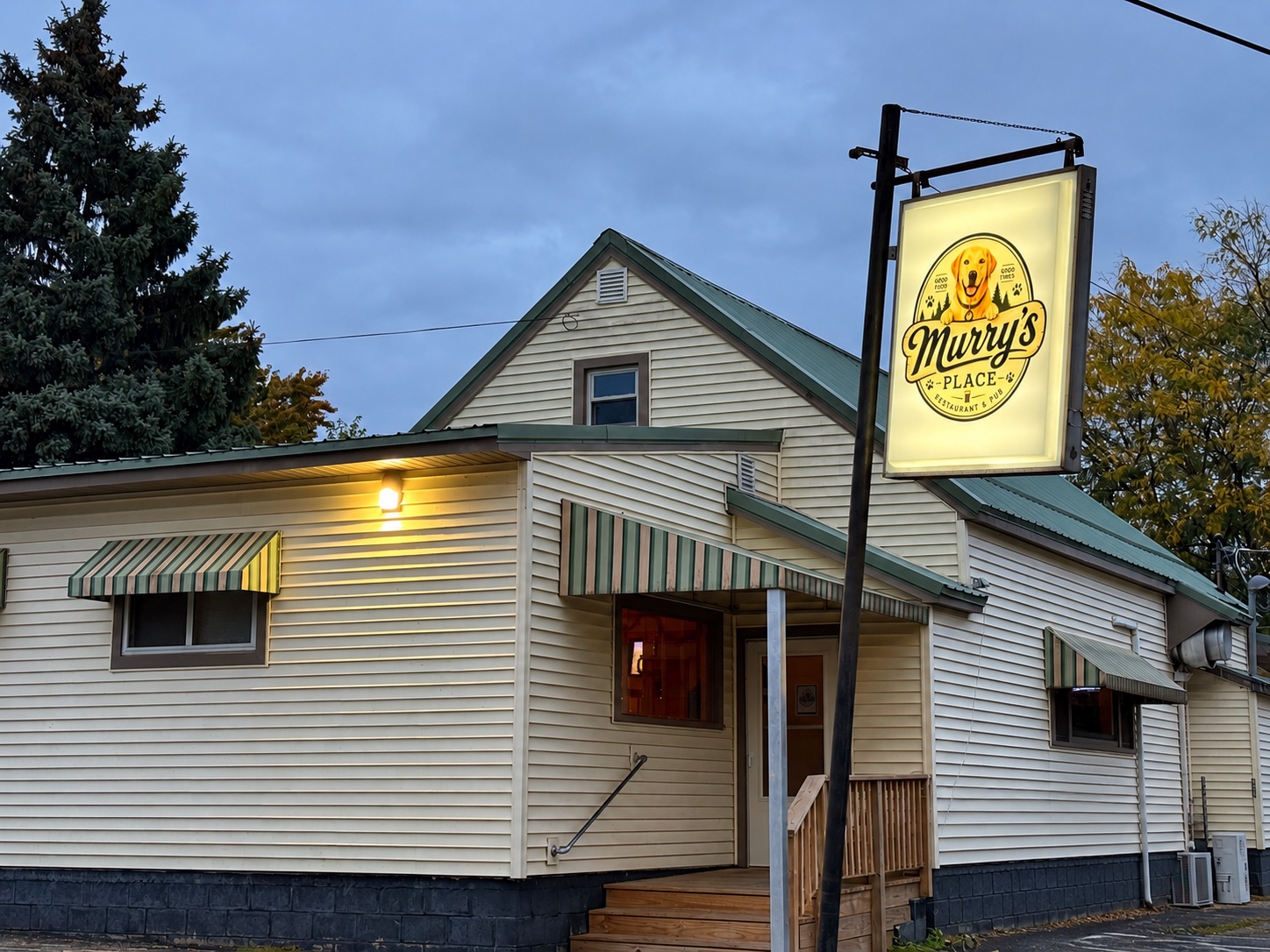 Exterior of Murry's Place Restaurant and Pub at 5756 Main Street in Butte des Morts, Wisconsin, featuring the illuminated Murry's Place sign